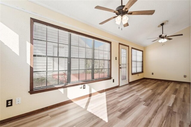 entryway with ceiling fan, light wood-type flooring, and vaulted ceiling