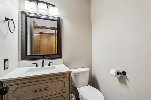 bathroom featuring toilet and vanity