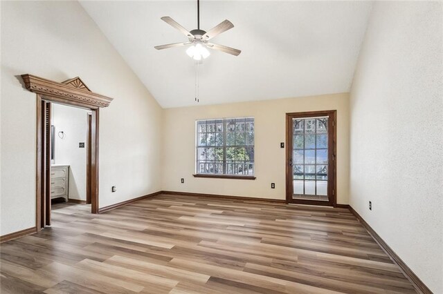 unfurnished living room with ceiling fan, wood-type flooring, and high vaulted ceiling