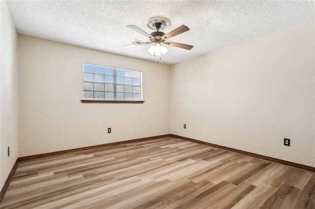 unfurnished room with ceiling fan, a textured ceiling, and light hardwood / wood-style flooring