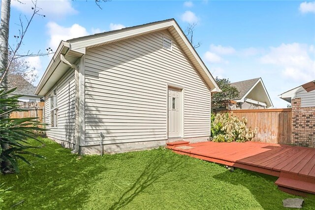 back of house featuring a yard and a wooden deck