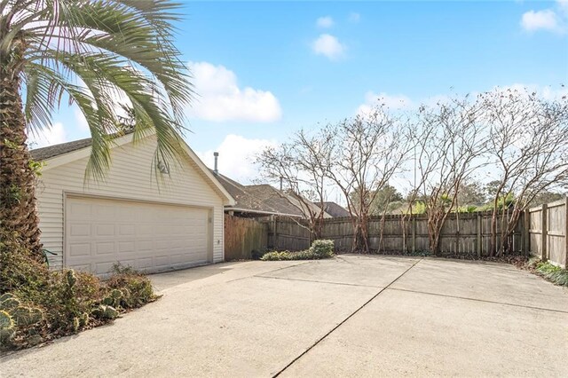 view of property exterior featuring a garage and an outdoor structure