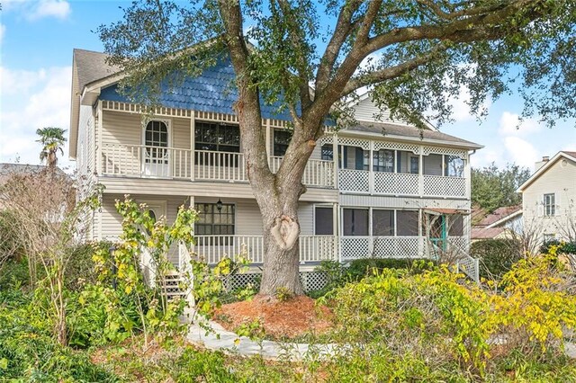 back of house featuring a balcony