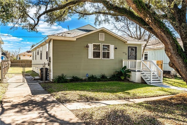 bungalow-style home with a front yard