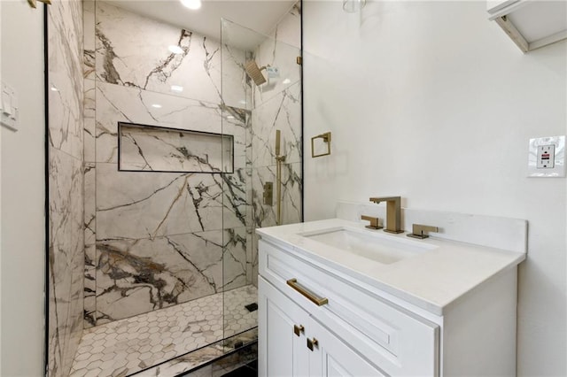 bathroom with vanity and tiled shower