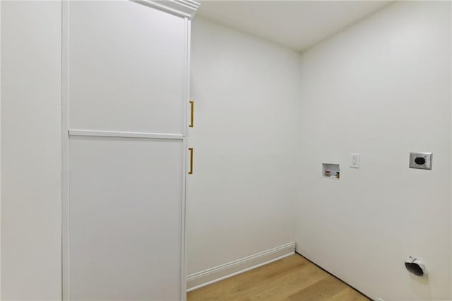 laundry area with light wood-type flooring, hookup for a washing machine, and hookup for an electric dryer