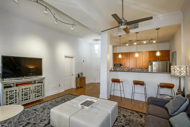 living room with ceiling fan and dark hardwood / wood-style flooring