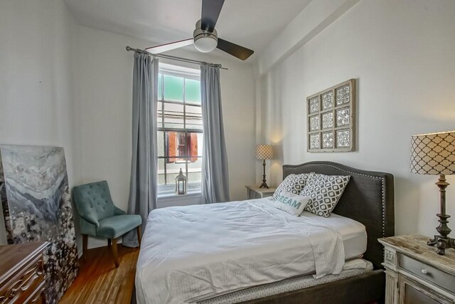 bedroom featuring ceiling fan and dark wood-type flooring