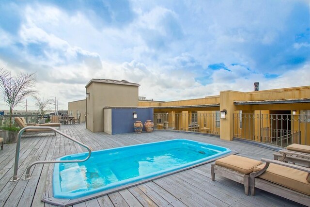 view of swimming pool featuring a wooden deck