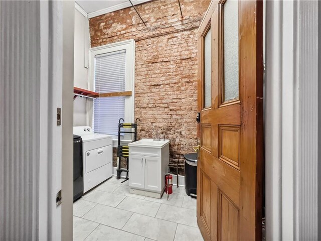 laundry room featuring washer / clothes dryer, sink, light tile patterned floors, and ornamental molding