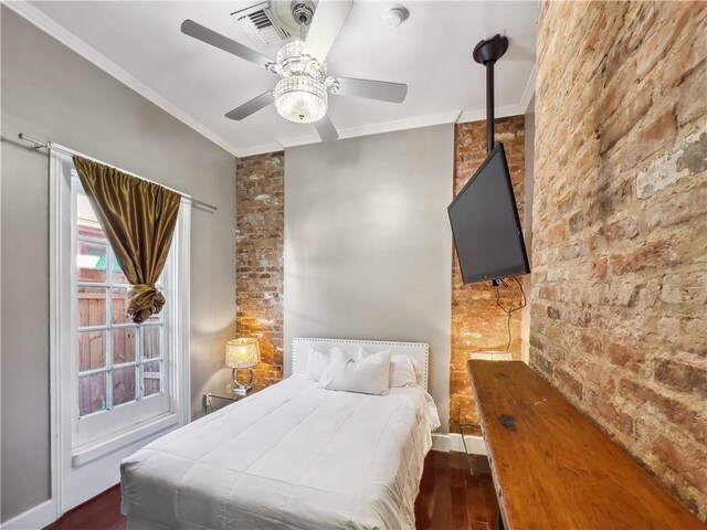 bedroom featuring ceiling fan, dark hardwood / wood-style floors, and crown molding