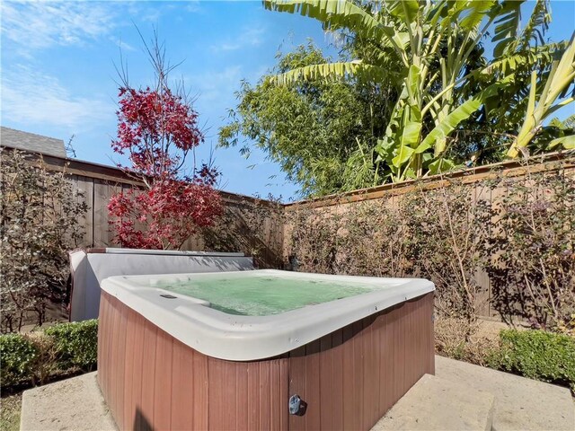 exterior space with a hot tub