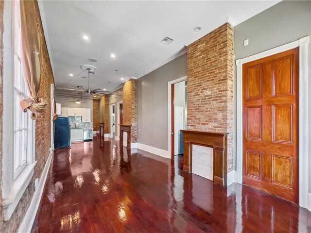 unfurnished living room featuring ceiling fan and ornamental molding