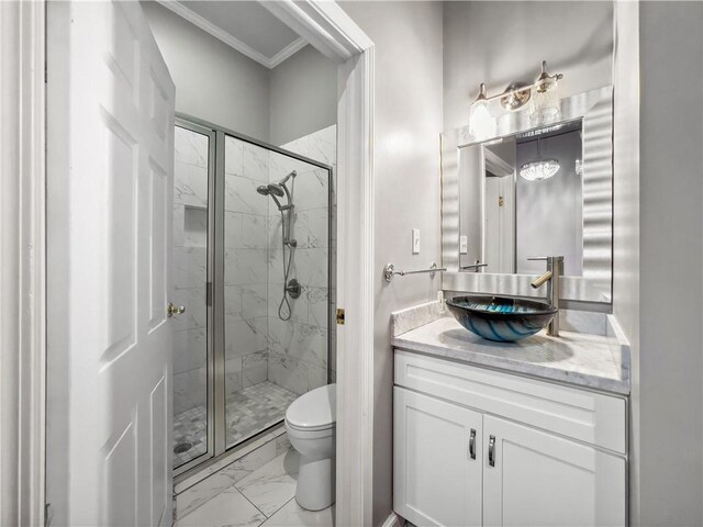 bathroom featuring a shower with shower door, toilet, vanity, and crown molding