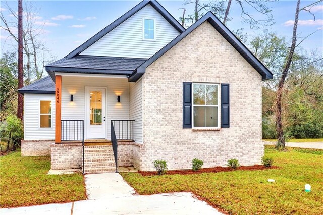 bungalow-style home featuring a front yard and a porch