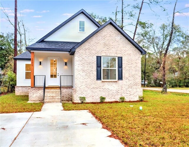 bungalow-style house with a front yard