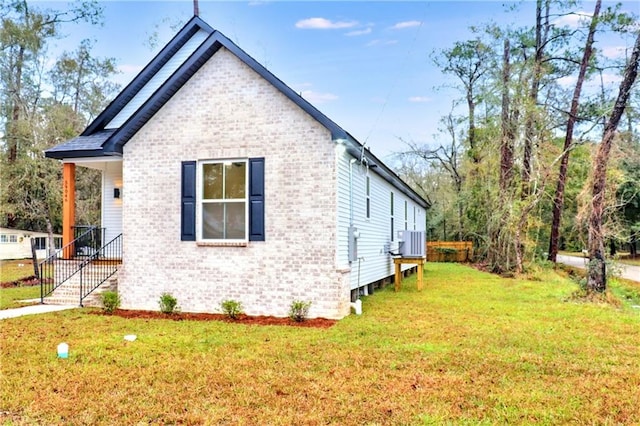 view of property exterior with cooling unit and a lawn