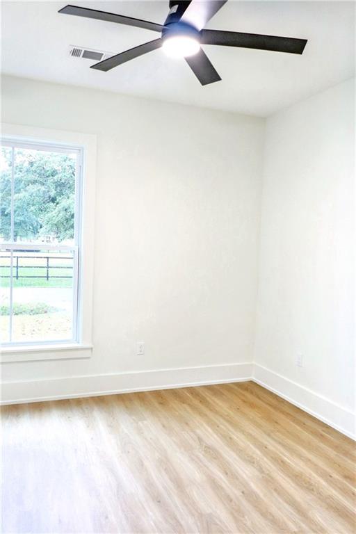 unfurnished room with a wealth of natural light and light hardwood / wood-style flooring