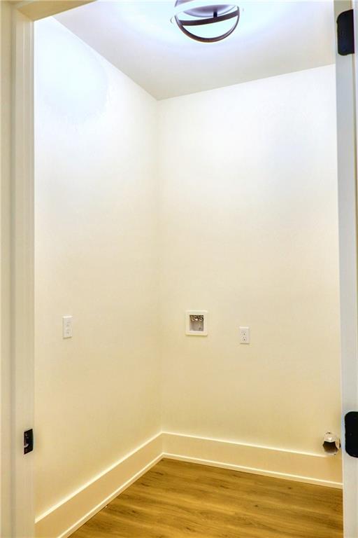 laundry area with hardwood / wood-style floors and hookup for a washing machine