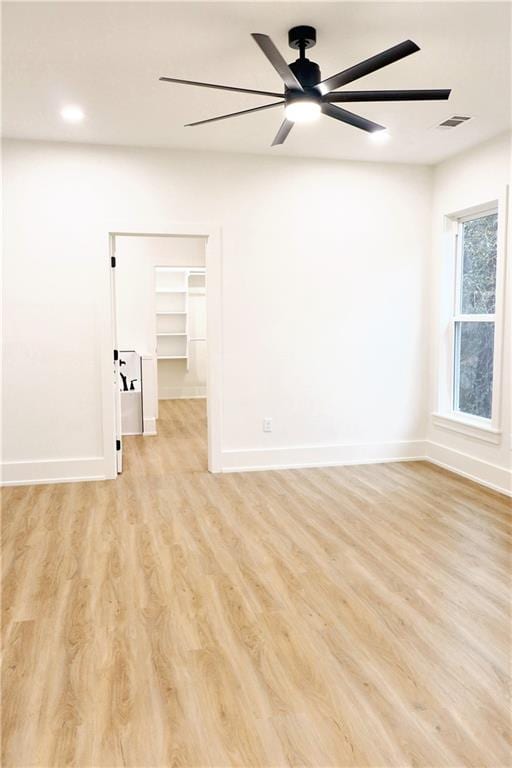 empty room featuring ceiling fan and light hardwood / wood-style floors