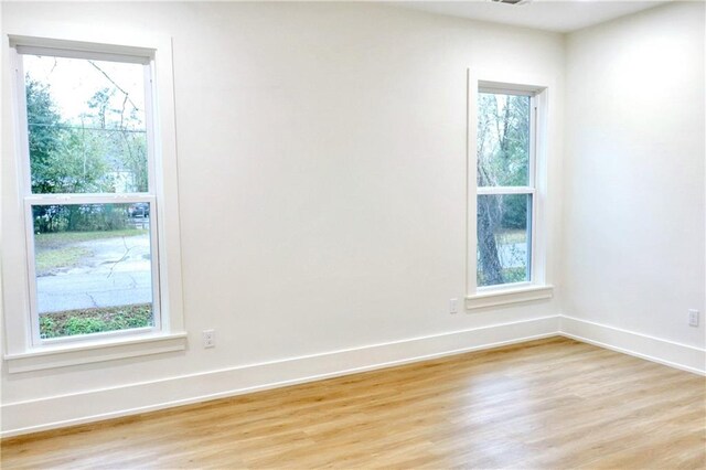 empty room featuring light hardwood / wood-style flooring and plenty of natural light