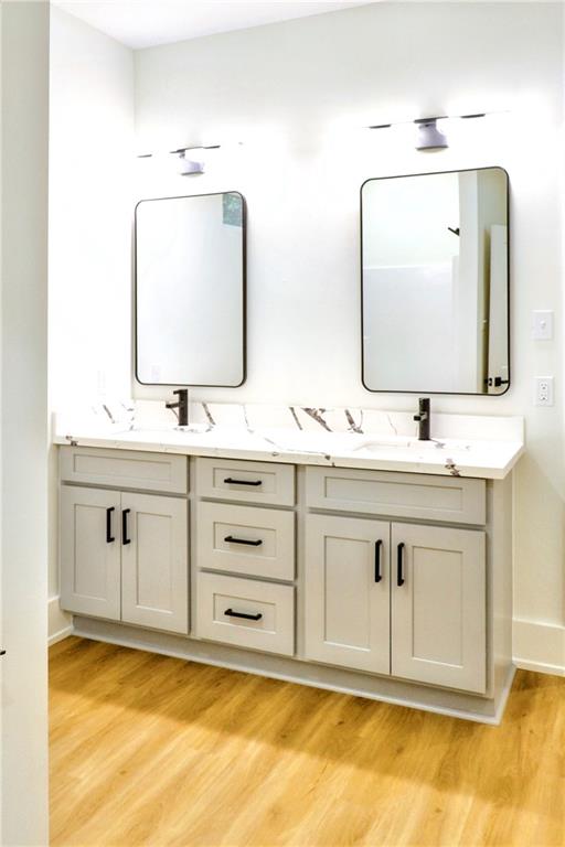 bathroom with vanity and hardwood / wood-style flooring