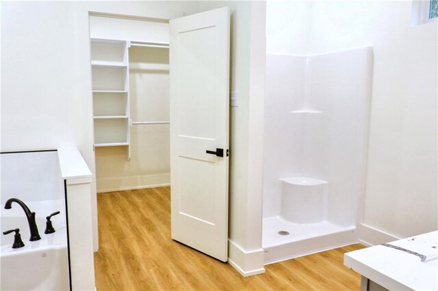 bathroom with wood-type flooring and a shower