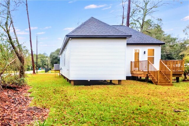 rear view of property with a lawn