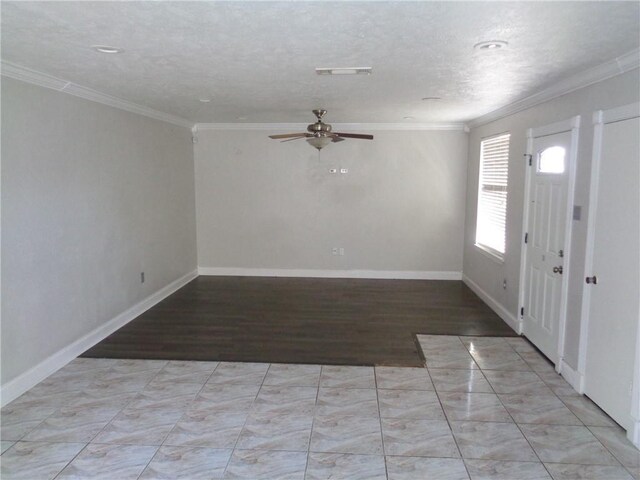 foyer entrance featuring ceiling fan, ornamental molding, and a textured ceiling