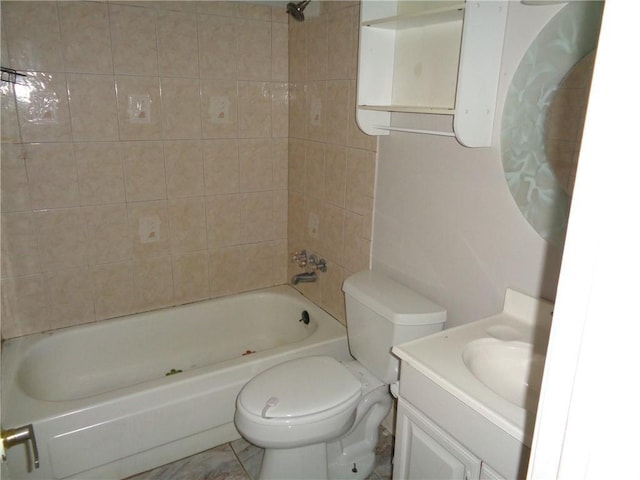 full bathroom featuring toilet, vanity, tiled shower / bath combo, and tile patterned flooring