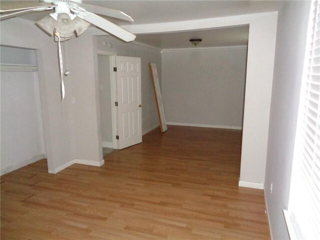 hallway with crown molding and light hardwood / wood-style floors