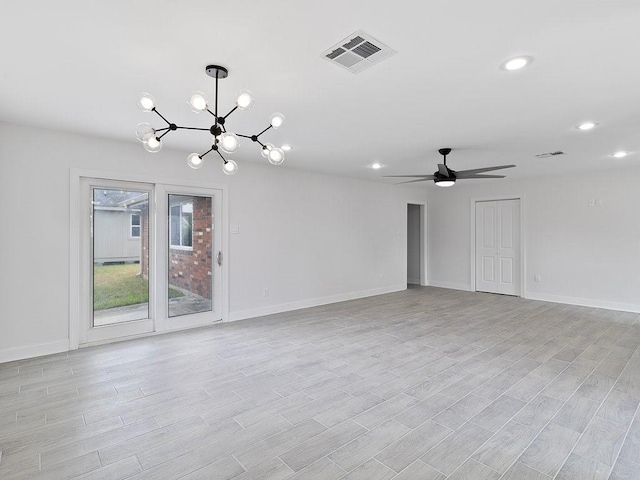 unfurnished room with ceiling fan with notable chandelier