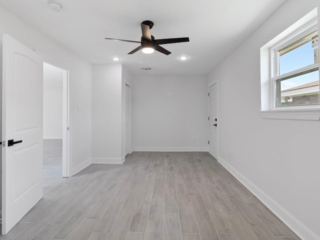 empty room featuring ceiling fan and light wood-type flooring