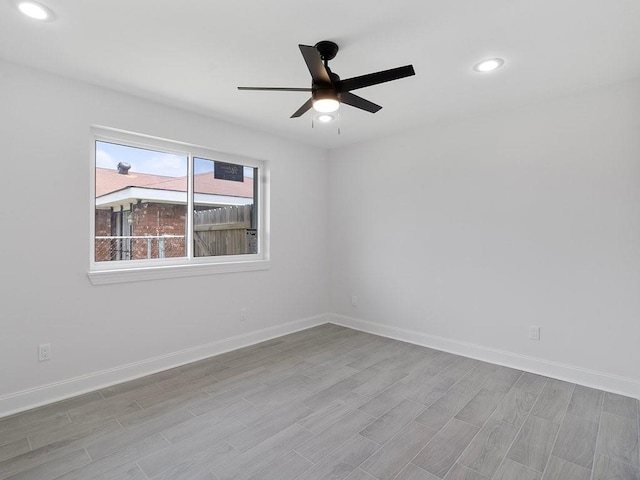 spare room featuring ceiling fan and light hardwood / wood-style floors