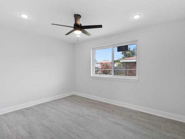 unfurnished room featuring light wood-type flooring and ceiling fan