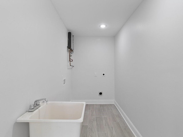 laundry area with hardwood / wood-style floors, hookup for a washing machine, and hookup for an electric dryer