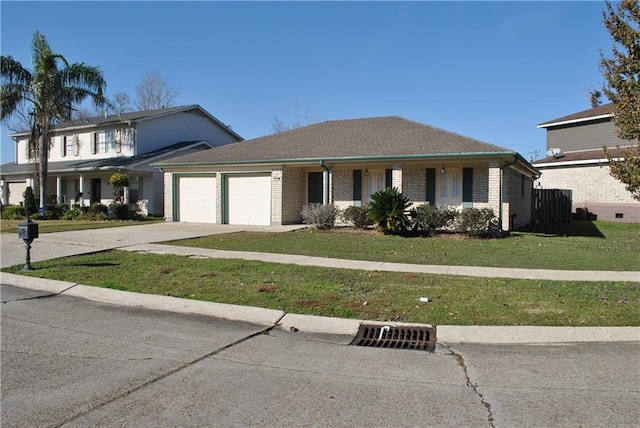 view of front facade with a front yard and a garage