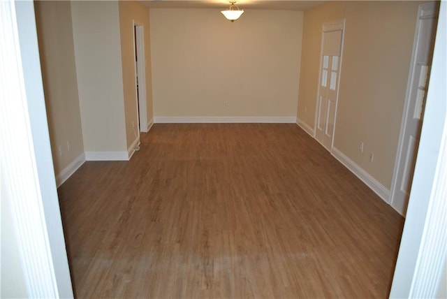 unfurnished room with wood-type flooring