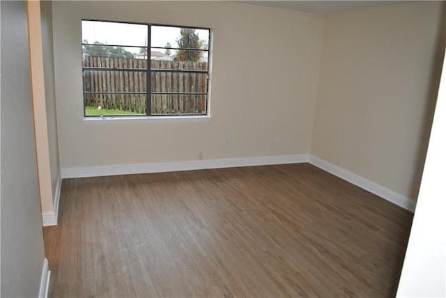 spare room with dark hardwood / wood-style flooring