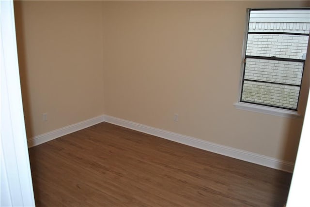 empty room featuring dark wood-type flooring