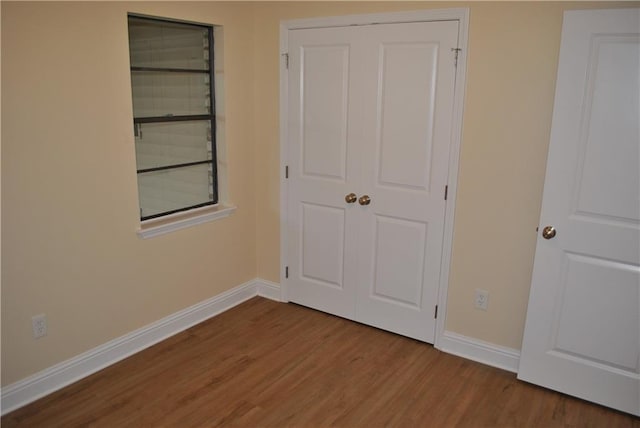 unfurnished bedroom featuring hardwood / wood-style flooring