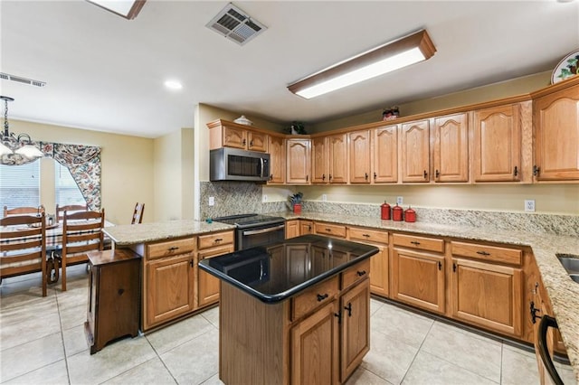 kitchen featuring light tile patterned floors, a kitchen island, range with electric cooktop, and decorative light fixtures