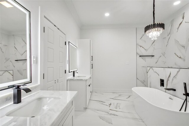 bathroom featuring vanity, a notable chandelier, and a tub to relax in