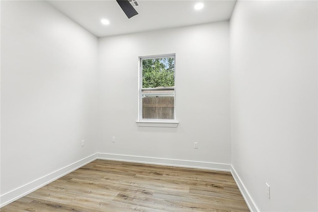 empty room with ceiling fan, recessed lighting, light wood-type flooring, and baseboards