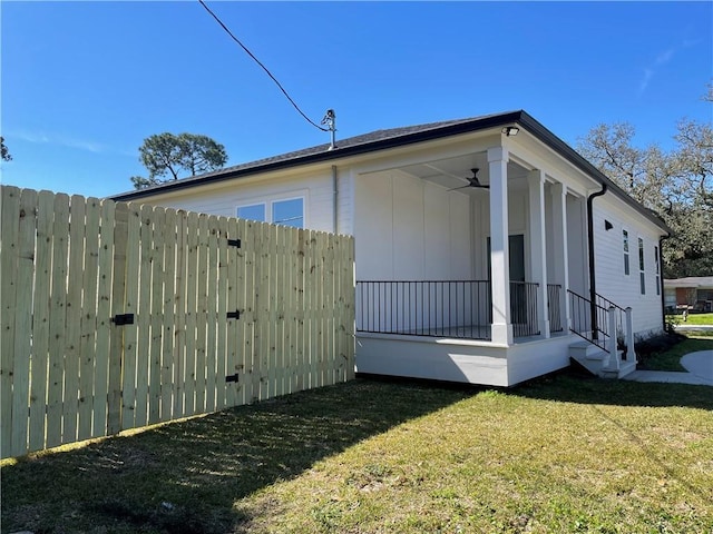 view of side of property with a yard and fence