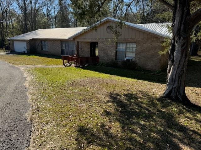 single story home with a front lawn and a garage