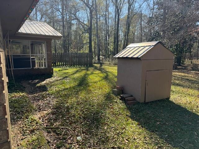 view of yard featuring a storage shed and a sunroom