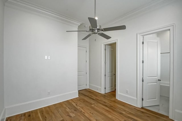 unfurnished bedroom featuring ceiling fan, crown molding, and light hardwood / wood-style flooring