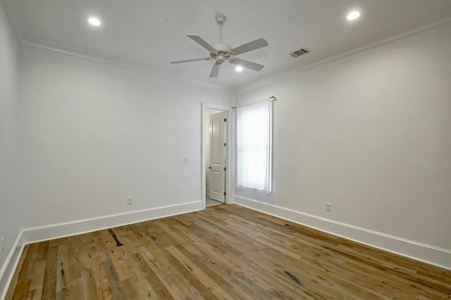 spare room with ceiling fan, ornamental molding, and light hardwood / wood-style flooring