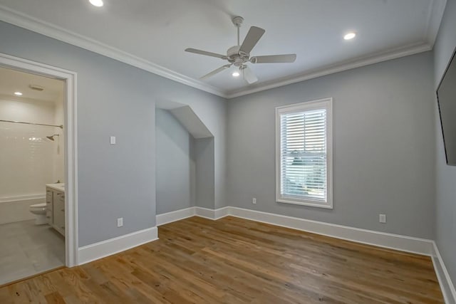 unfurnished bedroom with ensuite bathroom, ceiling fan, light wood-type flooring, and crown molding